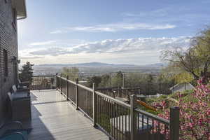 Wooden deck with a mountain view and a playground