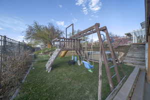 View of jungle gym with stairs and a pergola