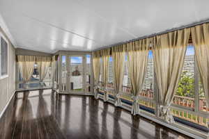 Sunroom with floor to ceiling windows for tons of natural light. Door leads to deck