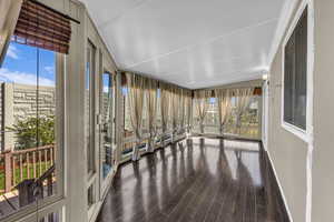 Sunroom with floor to ceiling windows for tons of natural light. Door leads to deck