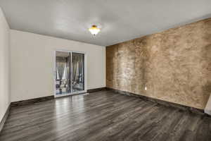 Family room with LVP flooring and sliding glass door to private sun room