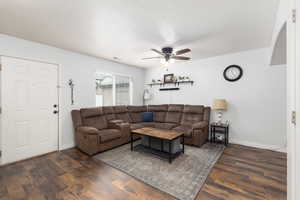 Living area with wood-type flooring, ceiling fan, and a textured ceiling
