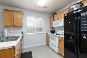 Kitchen with white appliances and light countertops