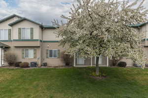 View of side of home featuring a yard and a central AC unit
