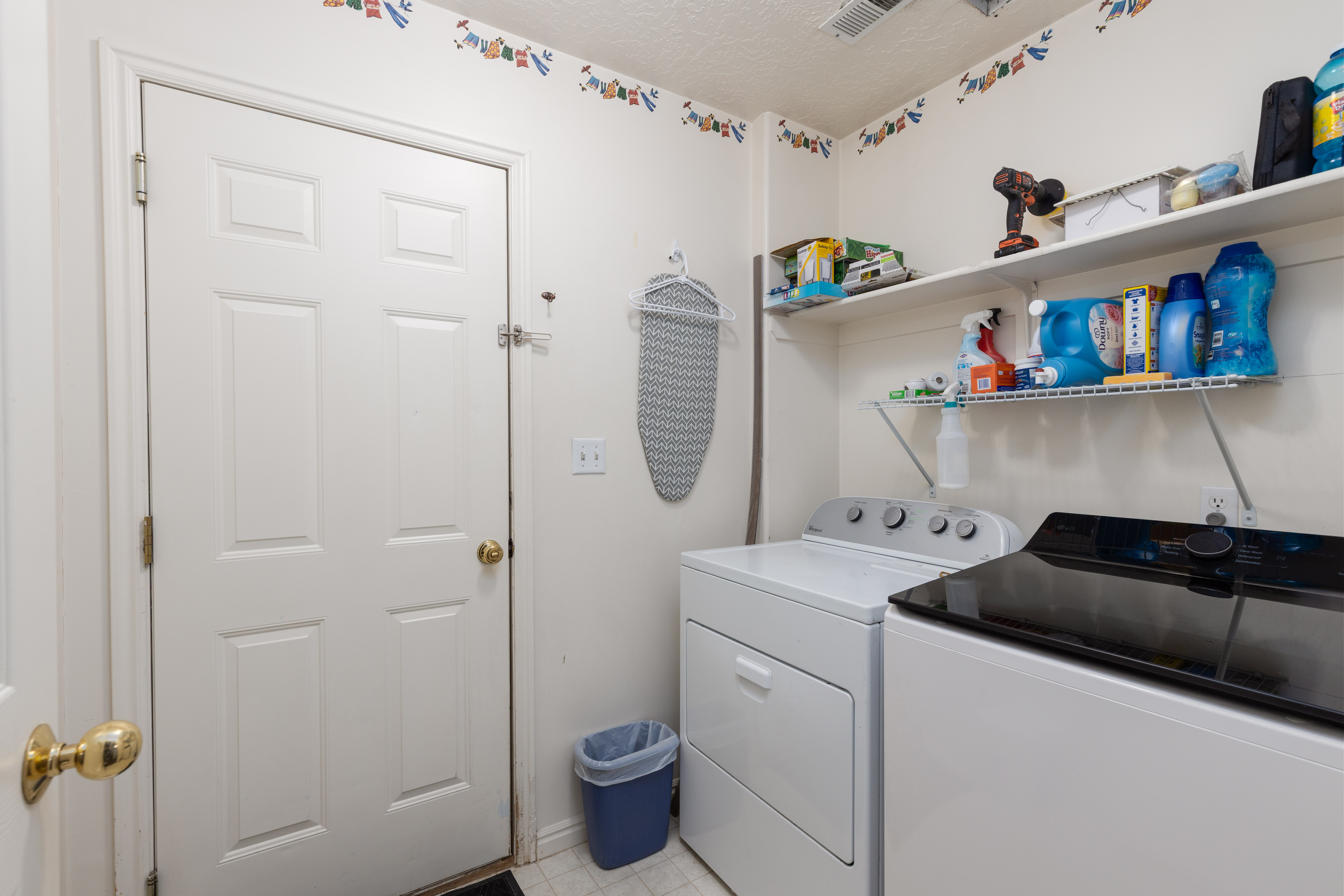 Laundry room featuring separate washer and dryer and a textured ceiling