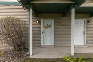 Doorway to property with covered porch