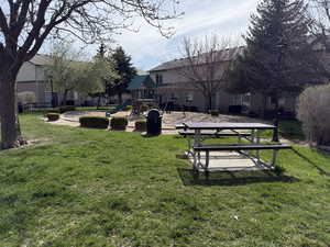View of grassy yard featuring a patio