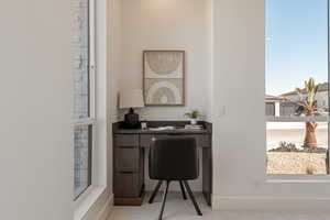 Office space featuring healthy amount of natural light and light colored carpet