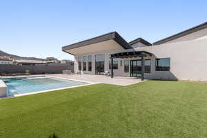 Rear view of property featuring a patio, a pergola, stucco siding, a fenced backyard, and a pool with connected hot tub
