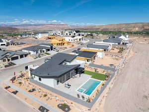 Aerial view of residential area with a mountainous background and a pool area
