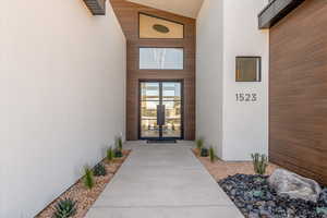 Doorway to property with stucco siding and french doors