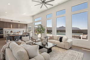 Living area featuring wood finished floors, recessed lighting, ceiling fan, a mountain view, and vaulted ceiling