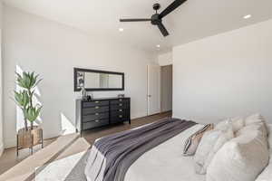Bedroom with a ceiling fan and recessed lighting