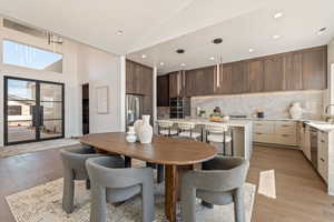 Dining area featuring lofted ceiling and light wood-type flooring