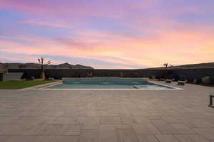 View of swimming pool with a fenced backyard and patio surround