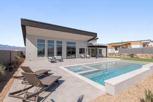 Integrated pool / hot tub featuring a patio area and a fenced backyard