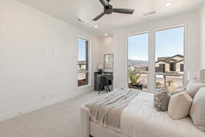 Carpeted bedroom with ceiling fan, recessed lighting, and an office area