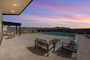 View of pool with patio surround, an outdoor lounge area, and a fenced backyard