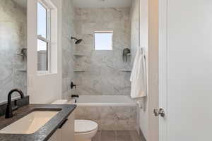 Full bath featuring vanity and washtub / shower combination