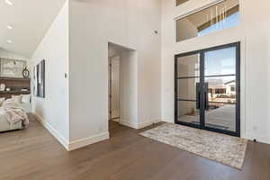 Entryway featuring dark wood-type flooring, vaulted ceiling, and recessed lighting