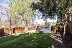 Fenced backyard featuring a deck