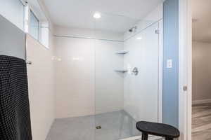 Bathroom featuring a tile shower and recessed lighting