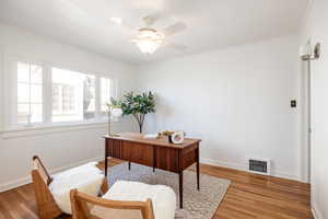 Office featuring ceiling fan, wood finished floors, and crown molding