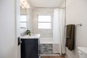 Full bathroom featuring tiled shower / bath, vanity, and light tile patterned floors