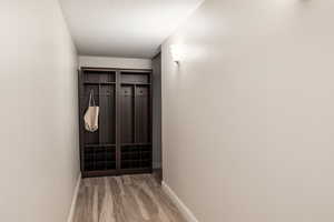 Hallway with baseboards and light wood-style flooring