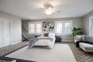 Bedroom featuring dark carpet, ceiling fan, and a closet