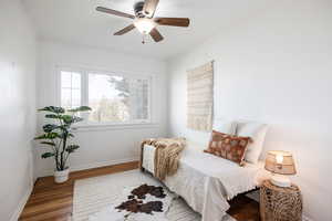 Bedroom with wood finished floors and a ceiling fan