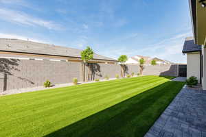 Fenced backyard featuring a patio