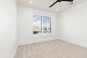 Spare room with light colored carpet, recessed lighting, and a ceiling fan