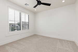 Spare room featuring recessed lighting, light carpet, and ceiling fan