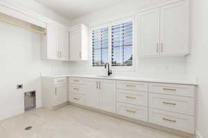 Laundry area with baseboards and cabinet space
