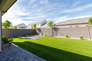 Fenced backyard featuring a patio