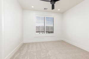 Unfurnished room with ceiling fan, light colored carpet, and recessed lighting