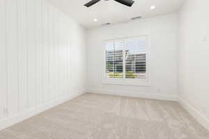 Spare room featuring recessed lighting, light colored carpet, and a ceiling fan