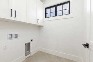 Laundry area featuring light tile patterned flooring, electric dryer hookup, cabinet space, and washer hookup