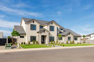 View of front of home featuring stucco siding and a tiled roof