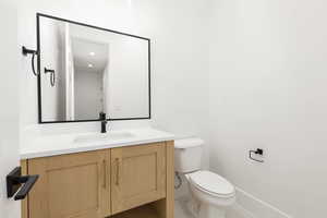 Bathroom featuring vanity and toilet