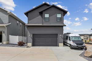View of front of home with driveway and an attached garage