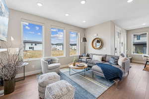 Living area featuring hardwood / wood-style flooring and recessed lighting