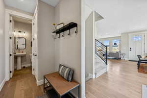Mudroom with light wood-style floors and recessed lighting