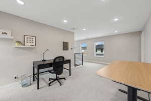 Office area featuring light carpet and recessed lighting