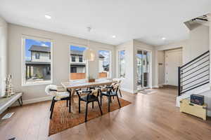 Dining room with light wood-type flooring and recessed lighting
