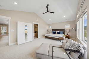 Bedroom with recessed lighting, ensuite bath, light colored carpet, vaulted ceiling, and a ceiling fan