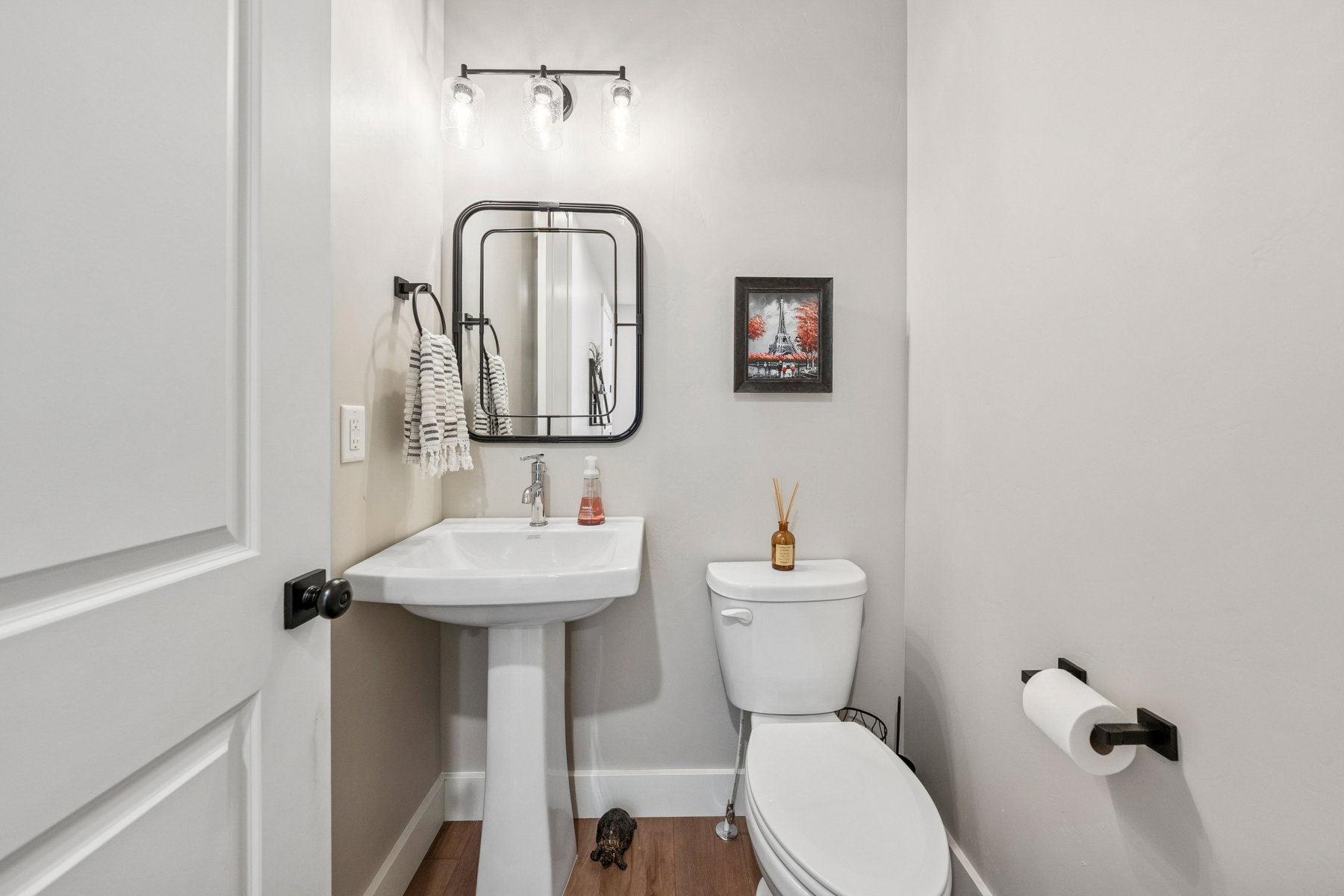 Bathroom with toilet and wood finished floors