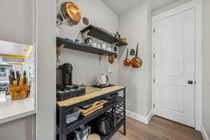 Kitchen featuring light wood-style floors and baseboards