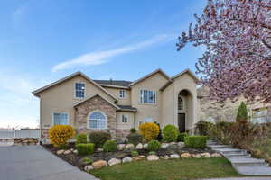Traditional-style home featuring stone siding and stucco siding